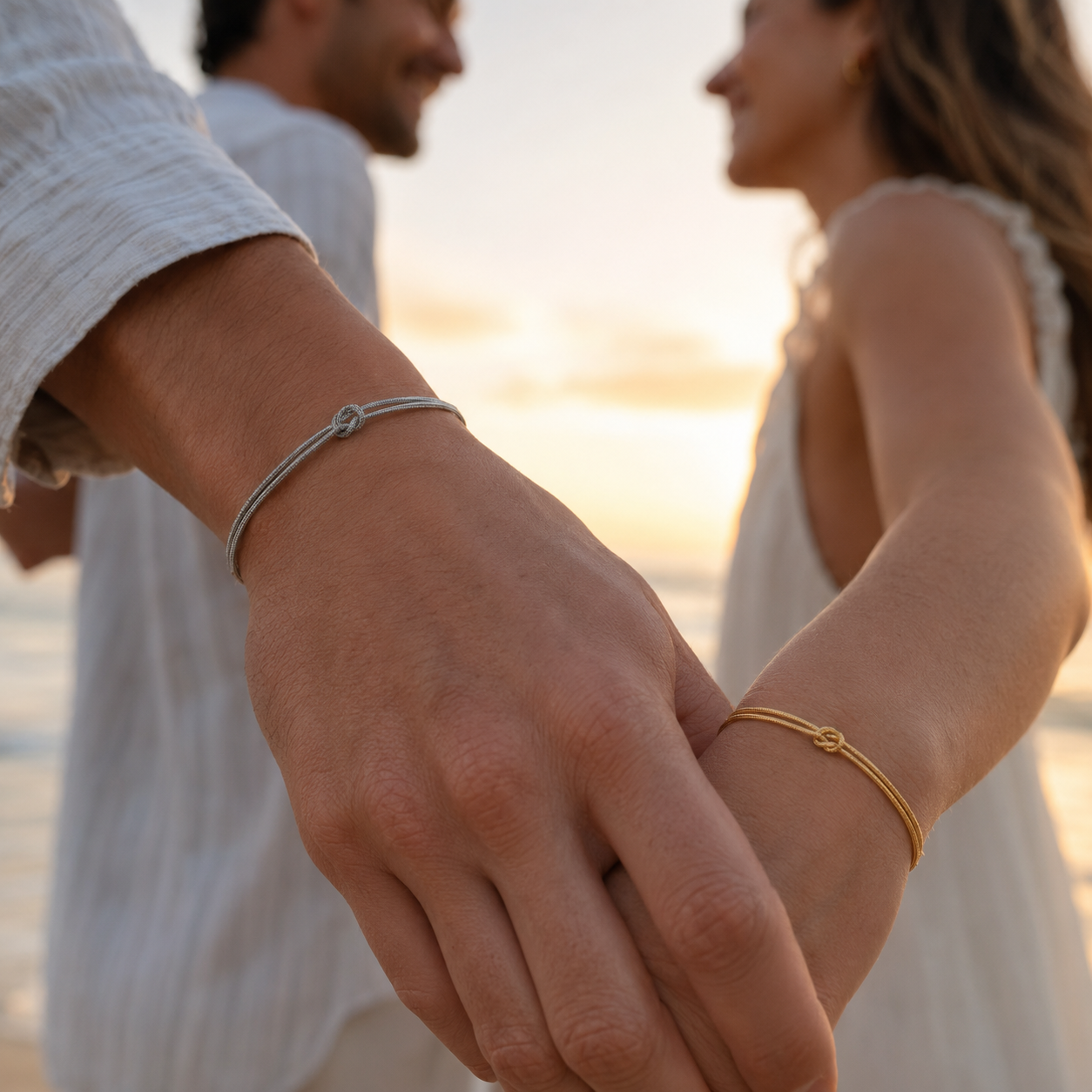 A couple holding hands with faithful Gold and Silver MURREN Forever Bond bracelets